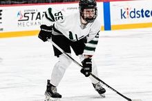 Sam Isbell lining up for a face-off in her PWHL Boston jersey