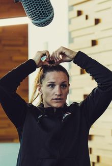 Jill Saulnier putting her hair into a ponytail during an interview