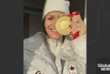 Global News thumbnail with Jill Saulnier holding up a gold medal while dressed in white olympic winter clothing