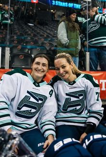 Susanna Tapani and teammate smiling for a photo on the bench.