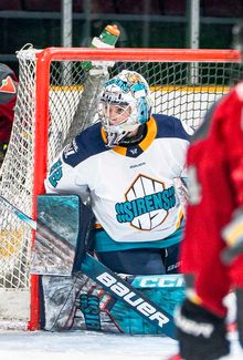Kayle Osborne hugging the net post.