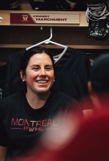 Kennedy Marchment sitting and smiling in her PWHL Montréal dressing room stall