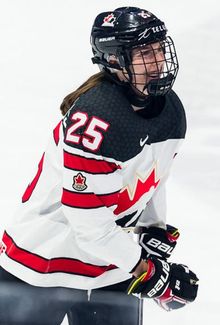 Jamie Bourbonnais (Team Canada) smiling and skating up the ice