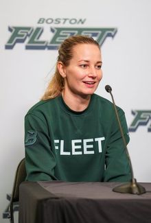 Susanna Tapani sitting in front of a microphone for an interview.