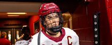 Abby Newhook in a Boston College jersey walking through the hallway.