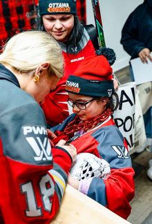 Mannon McMahon of the Ottawa Charge signing autographs,