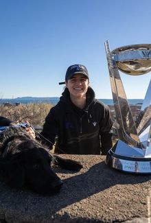 Michela Cava smiling next the Walter Cup and a black dog.