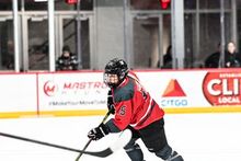 Savannah Harmon carrying the puck in her PWHL Ottawa jersey