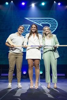 Abby Newhook smiling on stage after getting drafted to the Boston Fleet.
