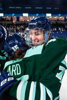 Susanna Tapani and teammates celebrating on the ice.