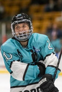 Hannah Brandt smiling during a stoppage at a PWHPA hockey game