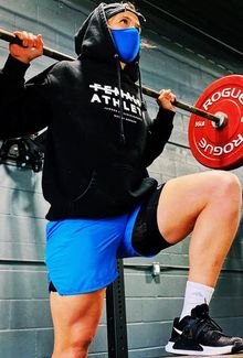 Jamie Lee Rattray working out and stepping up on a box with a barbell on her back