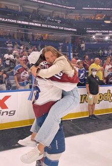 Abby Newhook hugging her brother Alex on the ice celebrating the Colorado Avalanche's 2022 Stanley Cup win.
