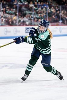 Susanna Tapani shooting the puck from the top of the circle.