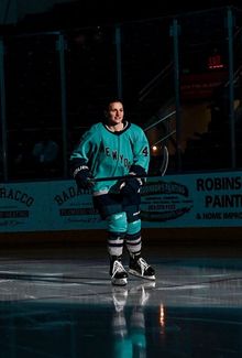 Jill Saulnier (PWHL New York) skating onto the ice with the lights off and a spotlight on her