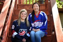 Hannah Brandt (Team USA) and her sister Marissa Brandt (Team Korea) posing for a photo in their team jerseys