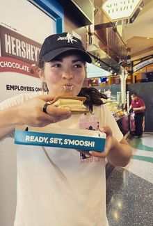 Nicole Hensley eating a giant smore at a Hershey's event