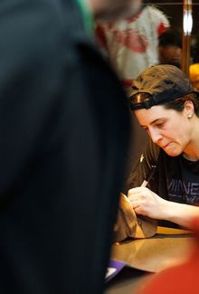 Michela Cava signing autographs.