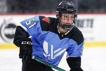 Brock University student and professional hockey player Victoria Bach wearing the purple jersey of team Toronto while skating on the ice during practice.